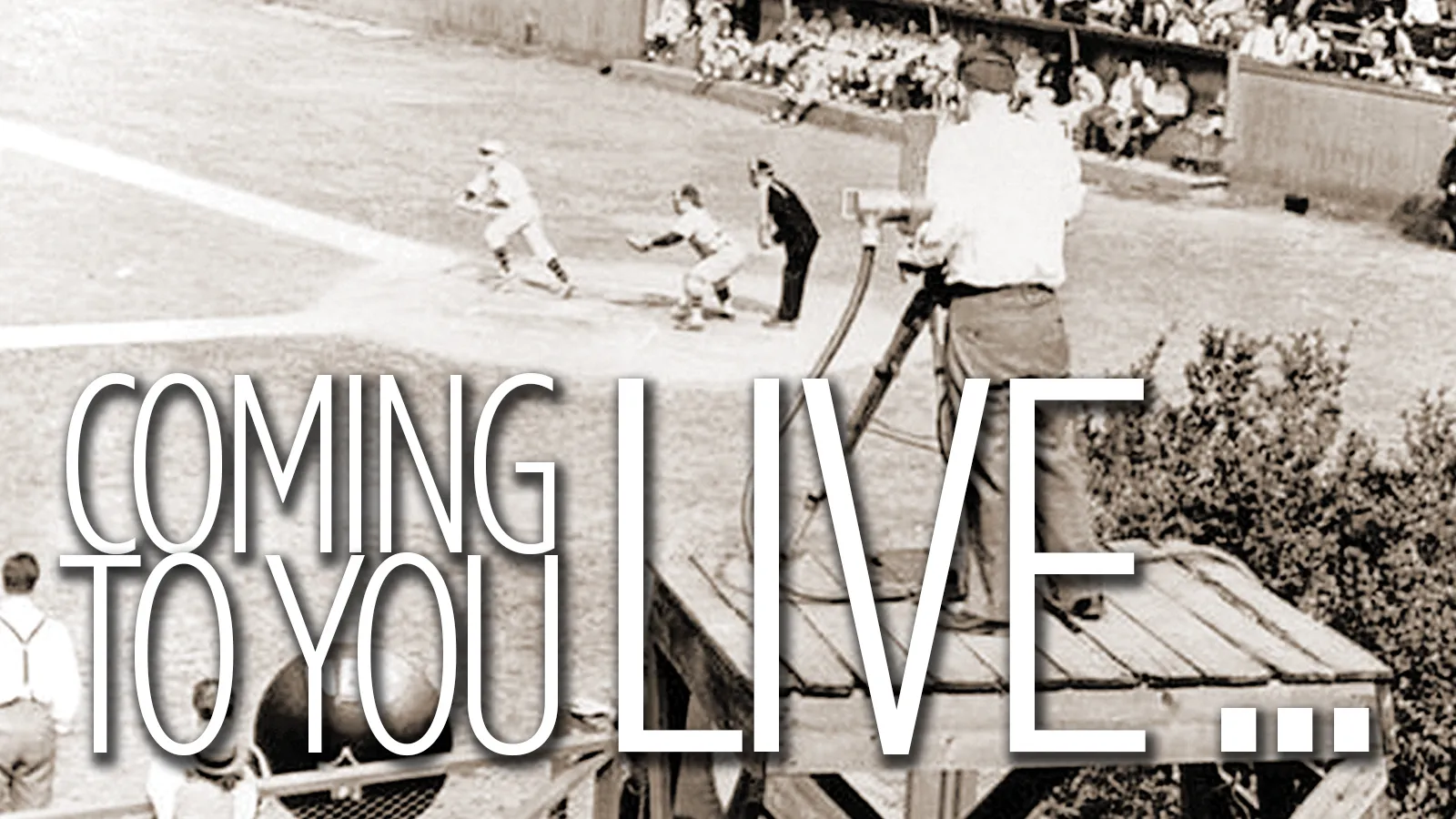 A photo taken of the first recording of a college baseball game! Several players play ball, under the foreground of a large camera recording them. The header caption over the image reads 'Coming to you live'
