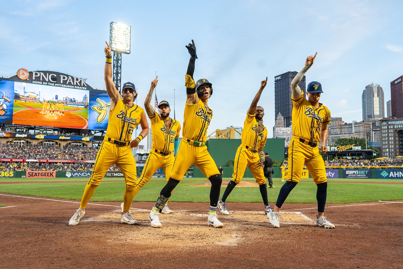 A group of Bananas dancing on the field.