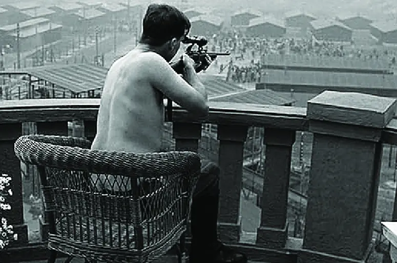Amon Goth on his perch, half undressed shooting at concentration camp inmates.