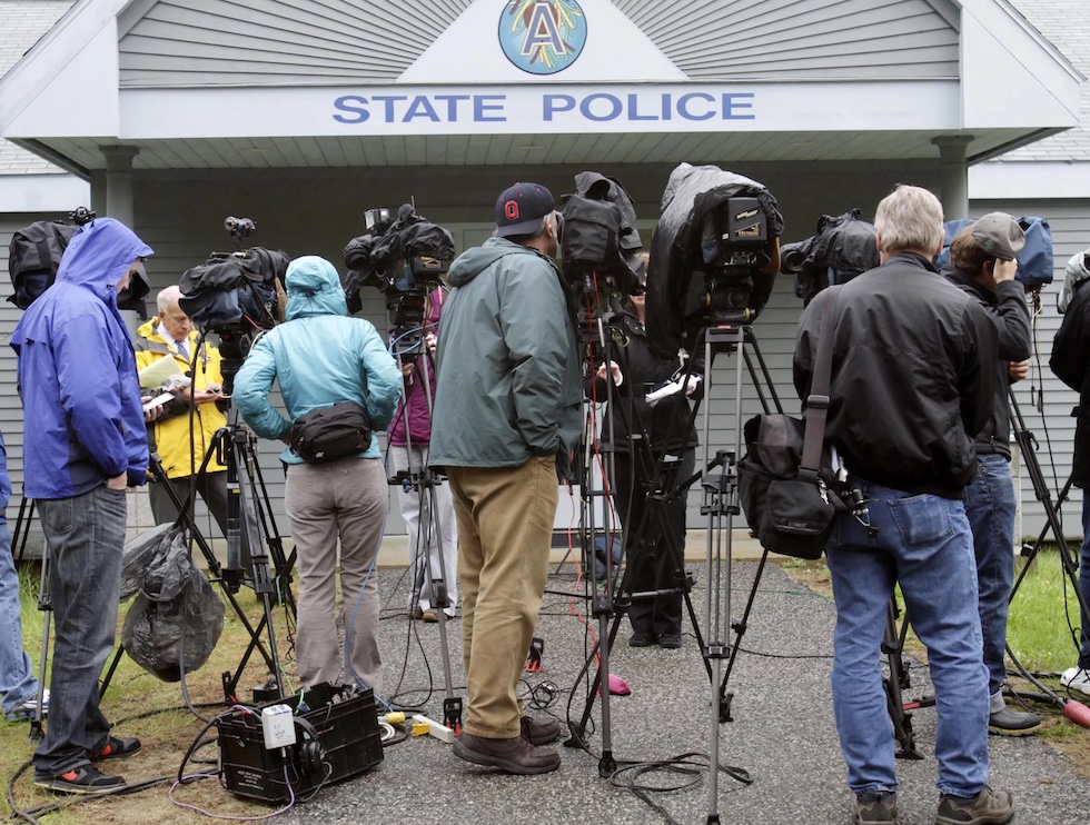 News media gathers outside the Maine State Police barracks prior to a brief news conference in May 2011