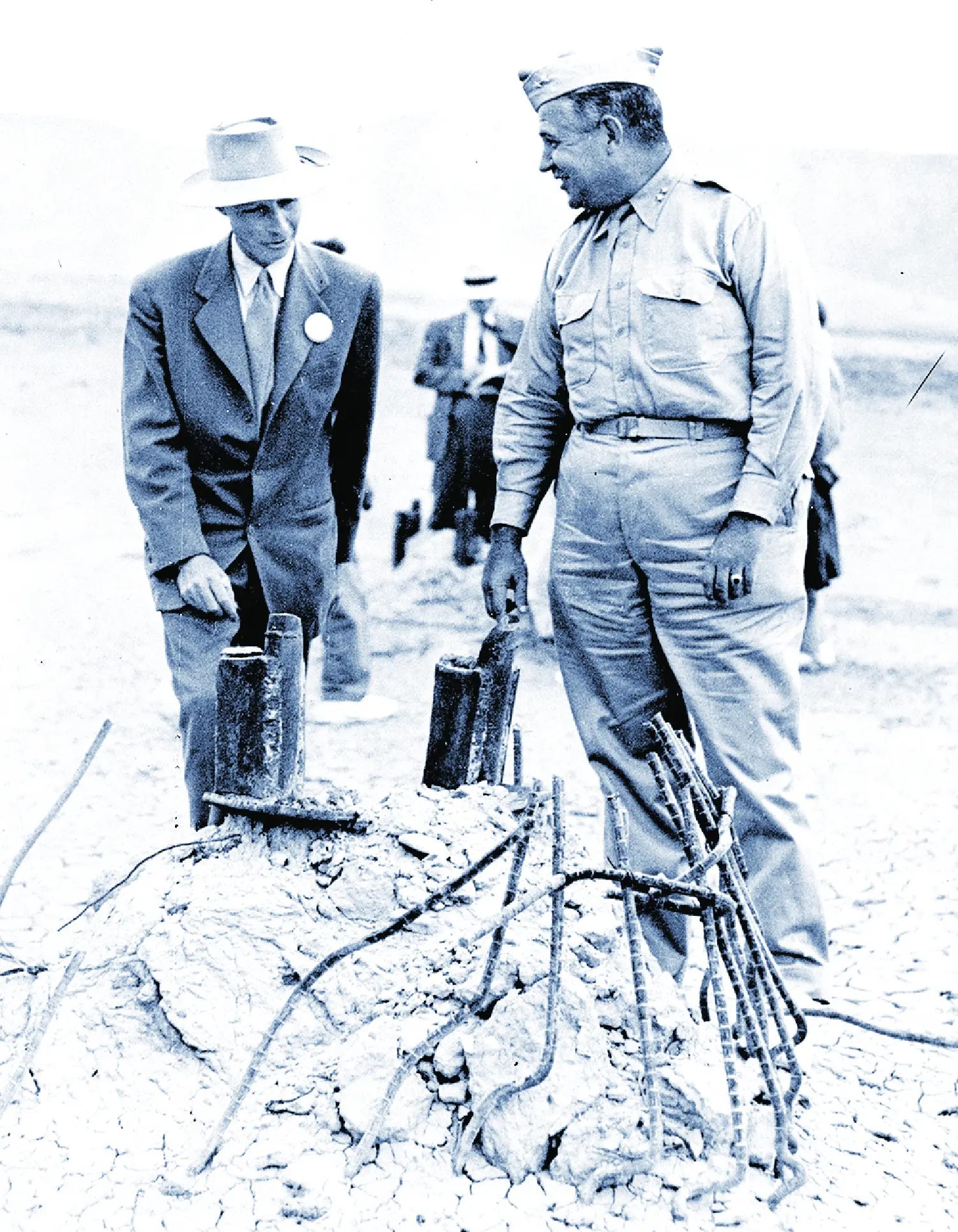 Oppenheimer and Groves inspect the wreckage of the 100-foot steel tower used to drop the nuke.