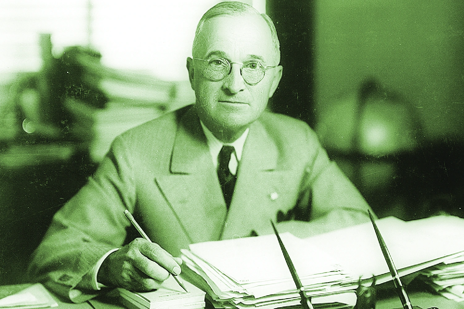 Truman sitting at his desk.