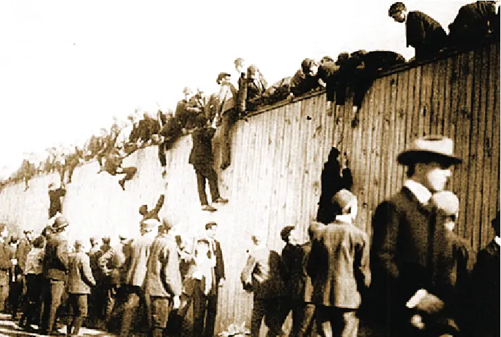 A dated photo of fans climbing over the walls into the first world series.